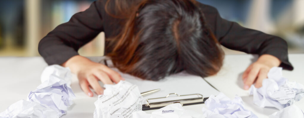 Stressed business woman make a mistake with chewed resume paper