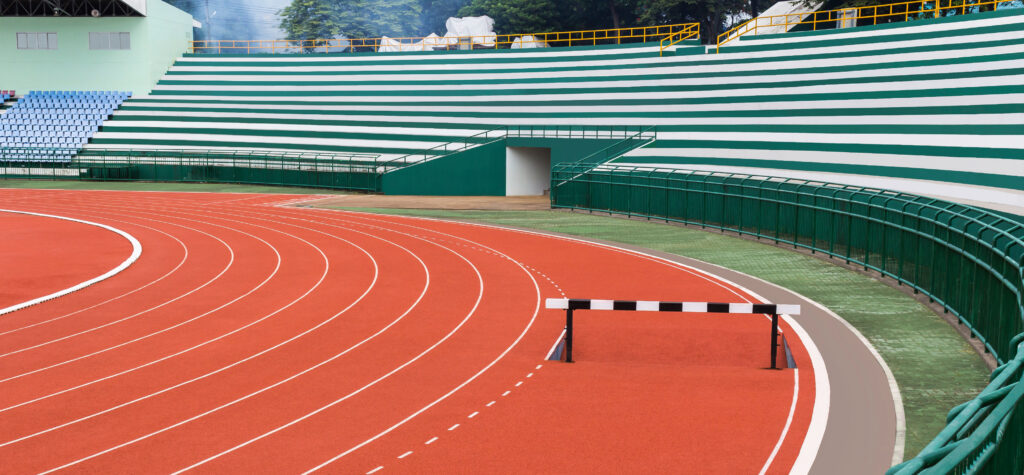 Hurdle on red running track in stadium