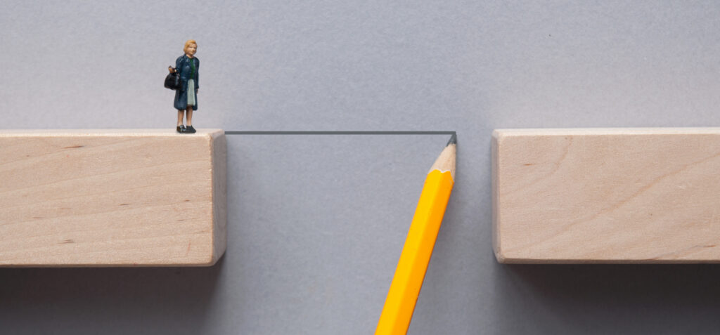 Pencil sketch bridging the gap between wooden blocks for female miniature figure to cross