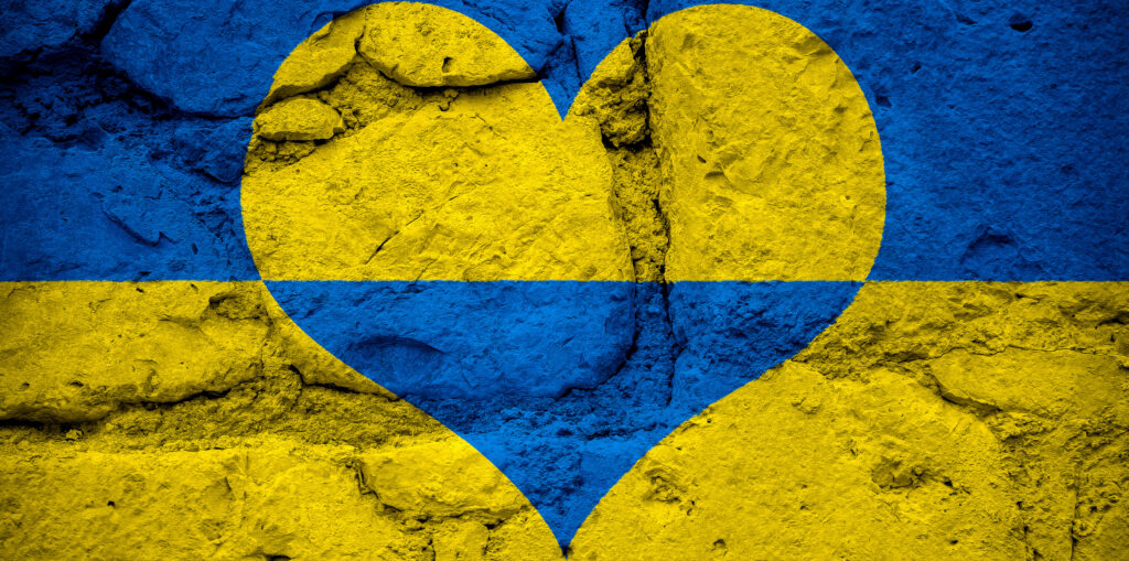 03 March 2022: Ukraine flag in national color yellow blue in heart shape on a stone wall, symbol of peace hope and pray for war in Ukraine PHOTO MOUNT *** Ukraine Flagge in Landesfarbe Gelb Blau in Herz Form auf einer Steinwand, Symbol für Friede Hoffnung und Beten für den Krieg in der Ukraine FOTOMONTAGE